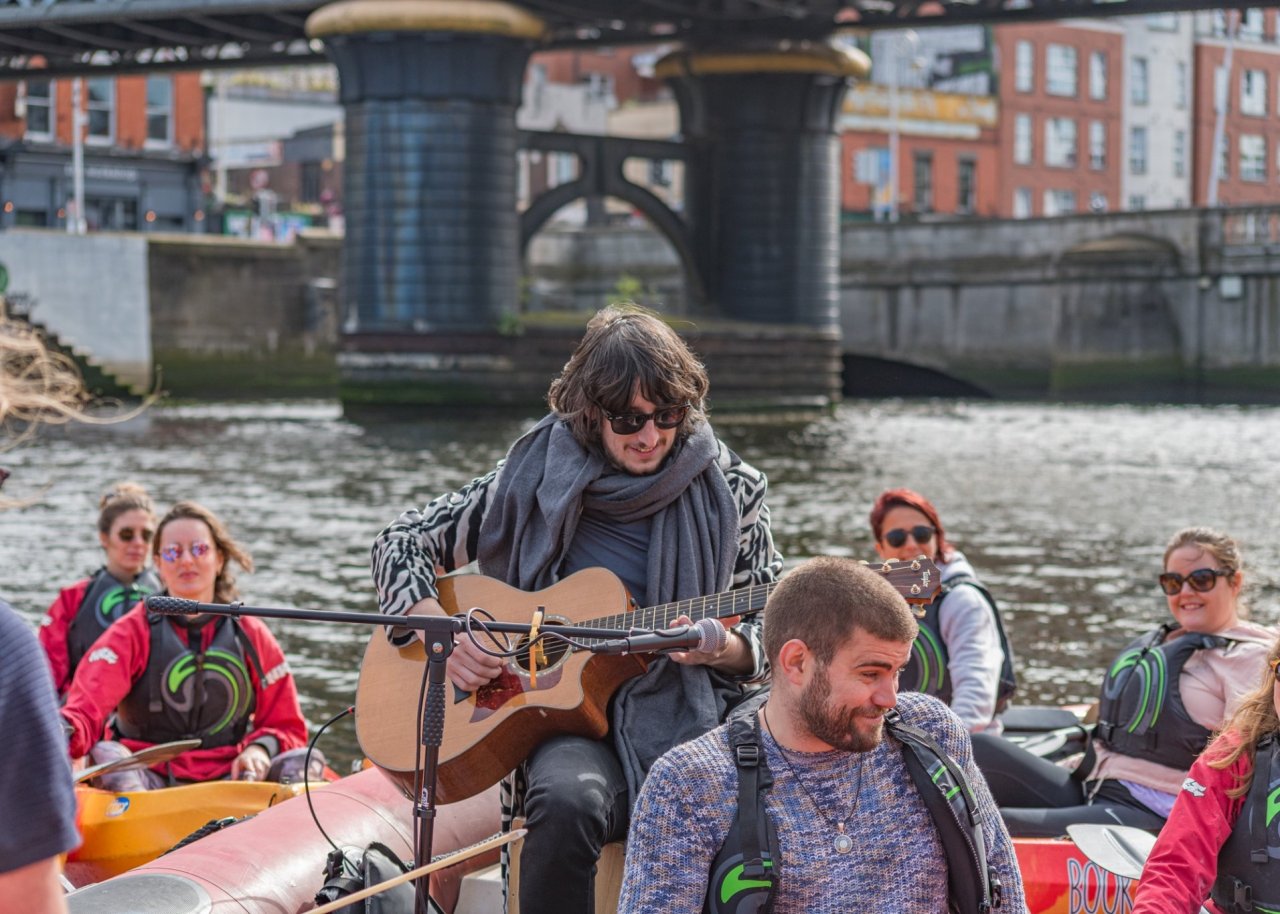 man playing guitar on water 