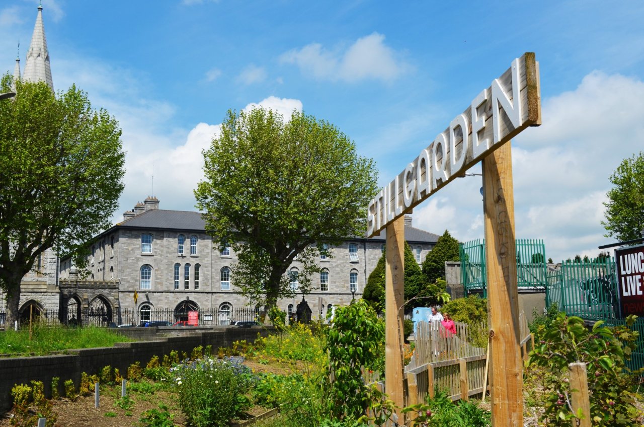 stillgarden sign outside stone building 